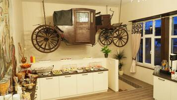 Experience the unique charm of this kitchen, featuring a vintage carriage suspended from the ceiling and a range of appliances.
