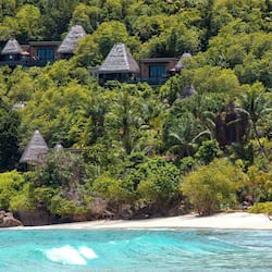 On the beach, white sand, sun loungers, beach umbrellas