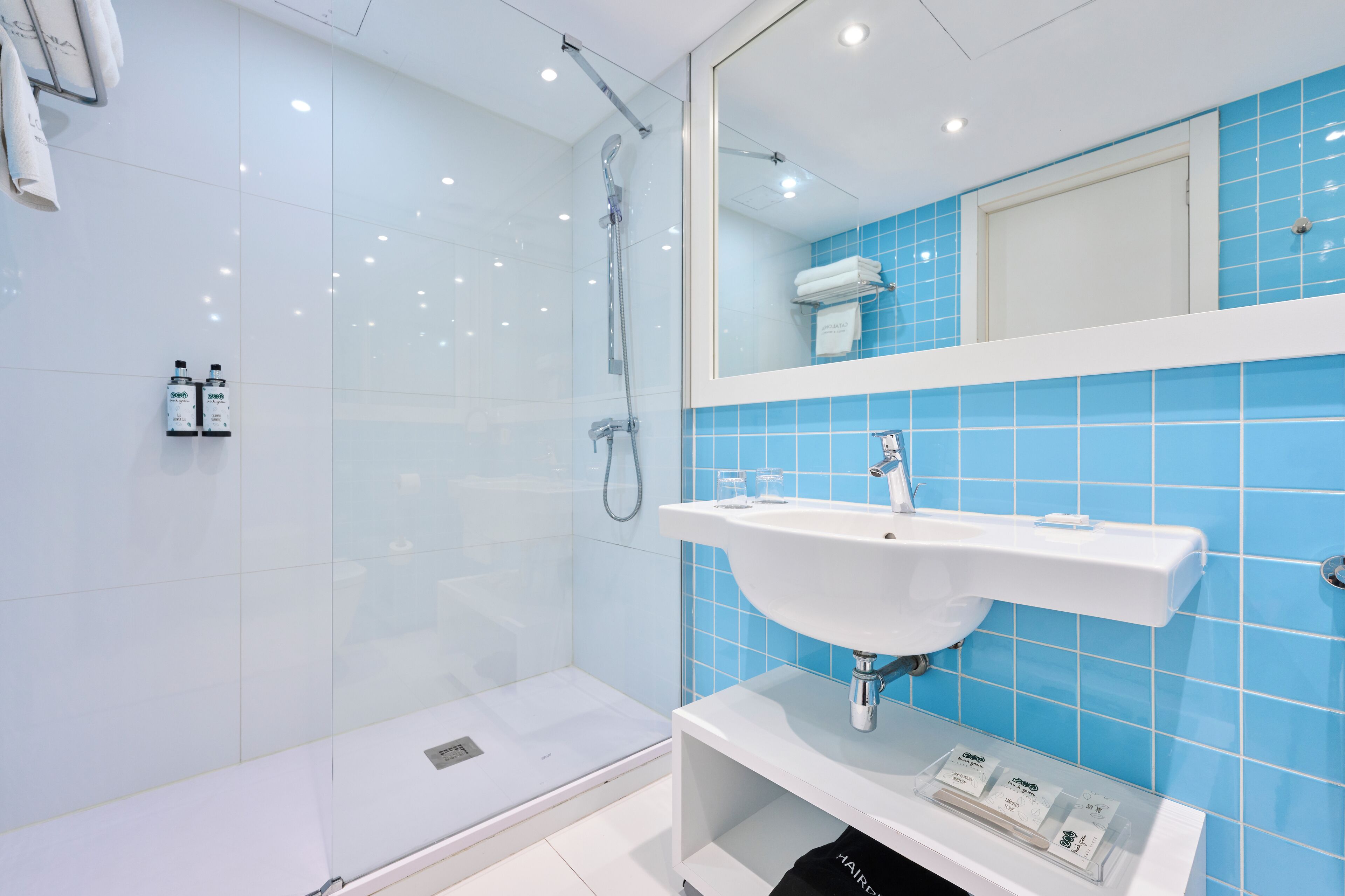 eco-friendly toiletries, hair dryer, towels