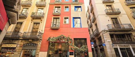 A street view of a building with a storefront named "NONSTOP" and a visible entrance.