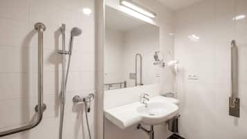 A modern bathroom with a white sink, mirror, and two showerheads.