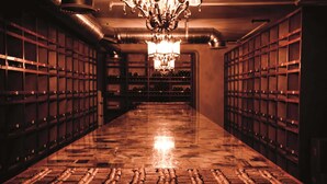 A wine cellar with wooden racks and a polished floor.