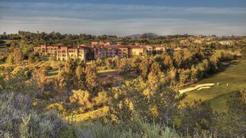 Escape to a serene Mediterranean-style resort surrounded by lush greenery and a well-maintained golf course.