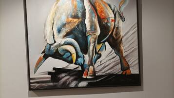 A painting of a bull on a black background.