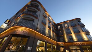 A multi-story hotel with balconies, a lounge area, and a restaurant named 'Brasserie'. - Le Berry (Saint-Nazaire)