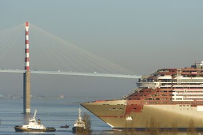 A large cruise ship docked near a bridge. - Le Berry (Saint-Nazaire)