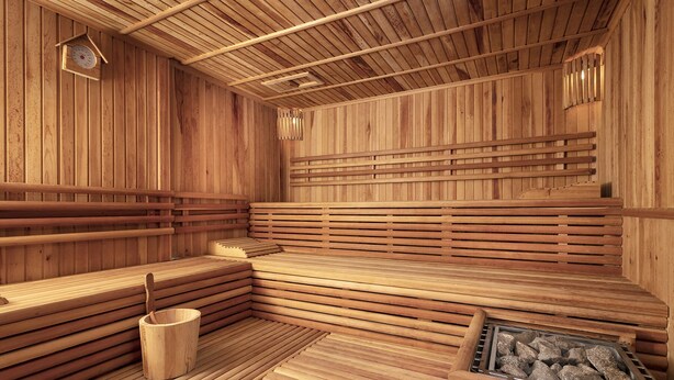 A wooden sauna with benches and a wooden bucket. - Dinc Hotel (Antalya)