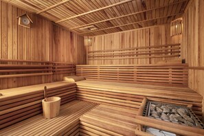Una sauna in legno con panche e un catino di legno.