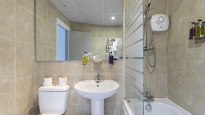 A bathroom with a toilet, sink, and bathtub.