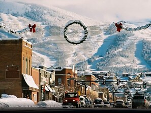 A snowy town with buildings and a mountain backdrop. - Ridgecrest Condominiums by Pioneer Ridge Management (Steamboat Springs)
