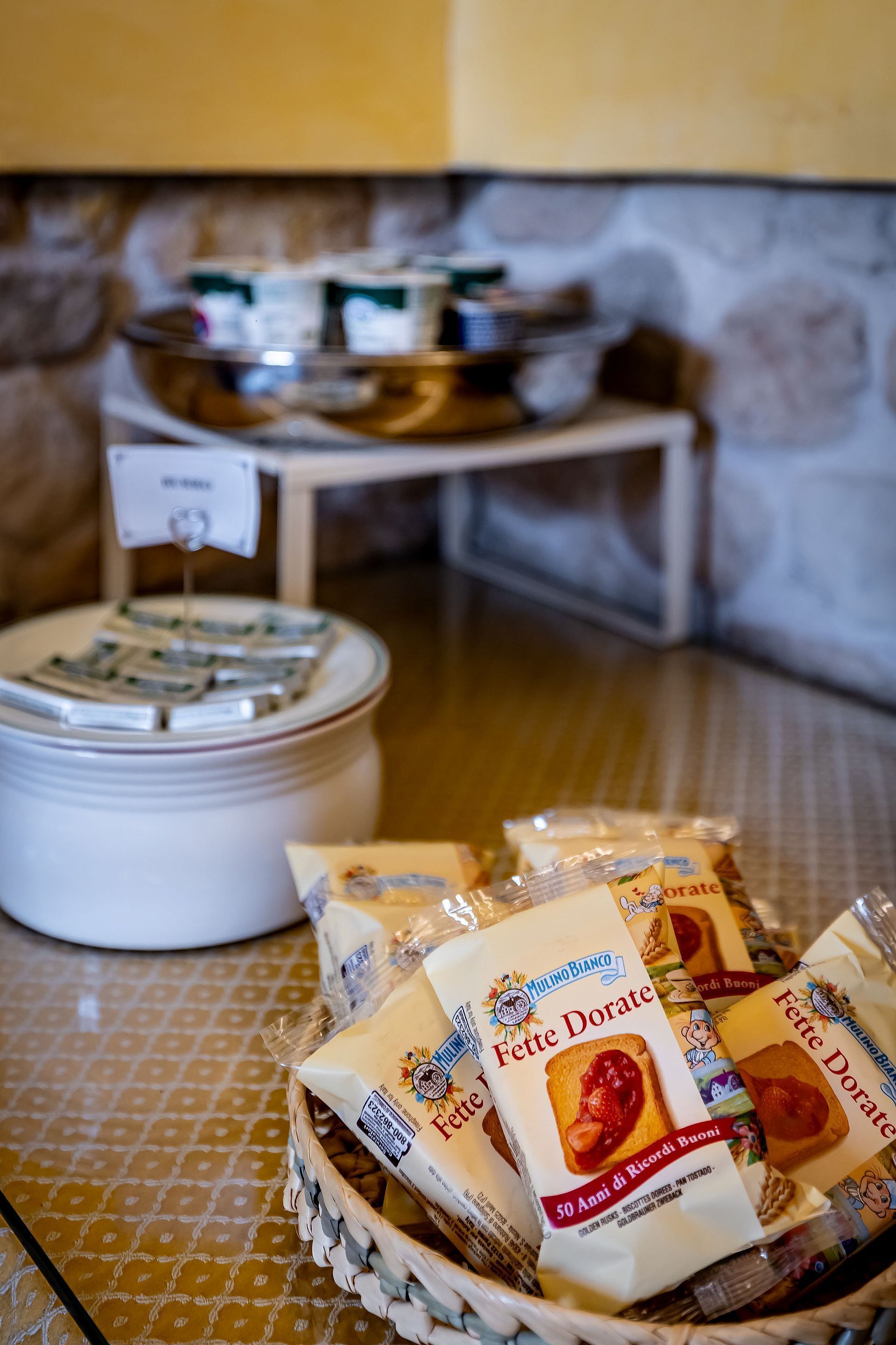 A buffet setup with packaged food items and a self-serve beverage dispenser.