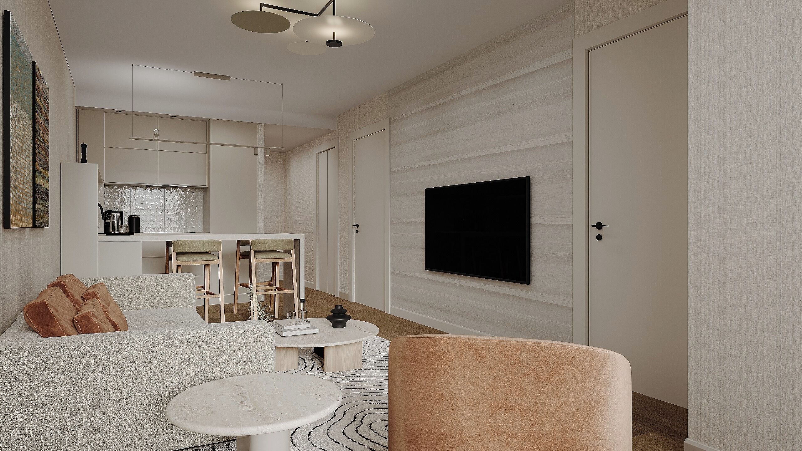 Una sala moderna con un televisor de pantalla plana montado en la pared, una zona de comedor con sillas y un sofá con cojines decorativos.