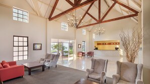 A spacious lobby with high ceilings, large windows, and a reception area. - Protea Hotel by Marriott Chingola (Chingola)