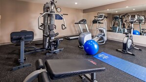 A gym with various exercise equipment including a treadmill, elliptical, and weight machines. - Best Western Lafayette Inn (Lafayette)
