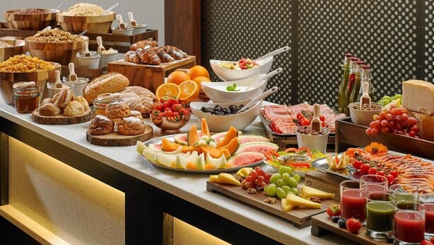 A buffet with various food items including fruits, cheeses, and meats. - The Gateway Hotel (Dundalk)