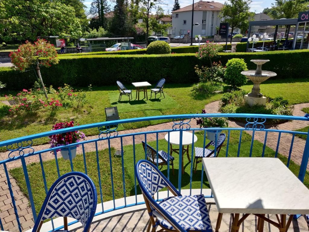A patio area with blue and white patterned chairs and a table, surrounded by a blue railing.
