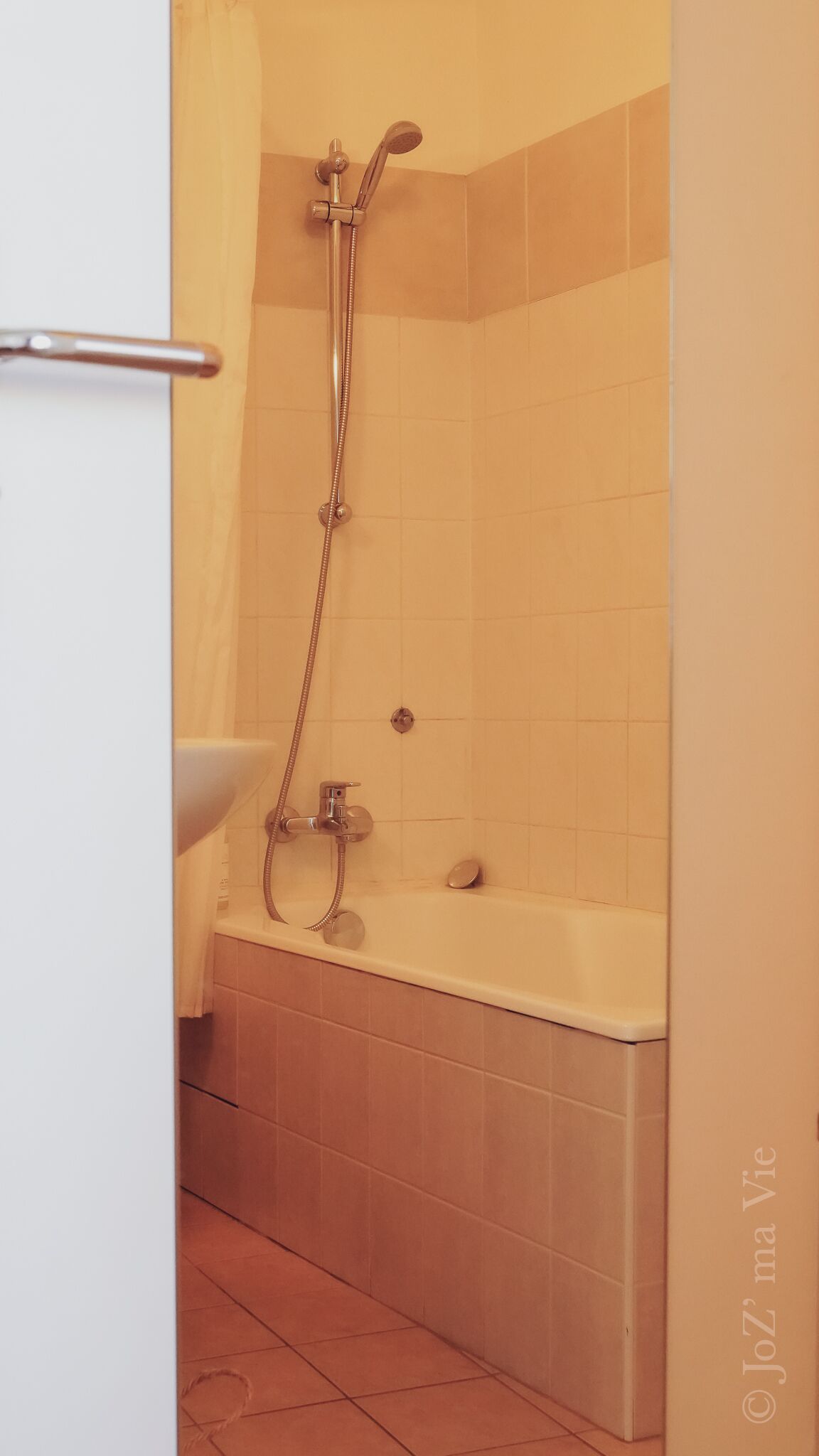A bathroom with a bathtub, a shower, and a sink.
