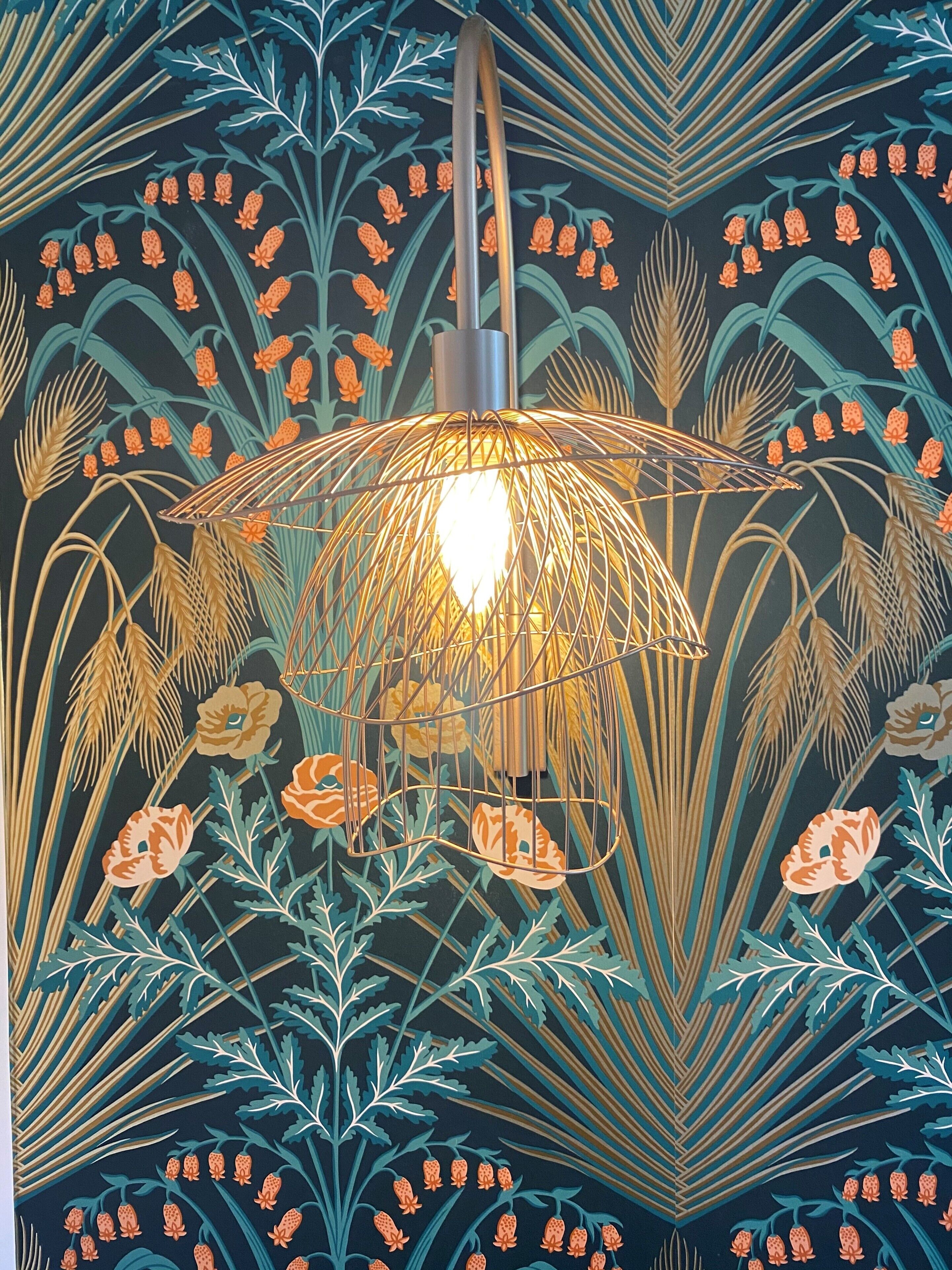 A wall with a decorative pattern of leaves and flowers.