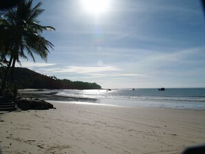 Pantai berhampiran, pasir putih, kerusi lepak pantai, payung 