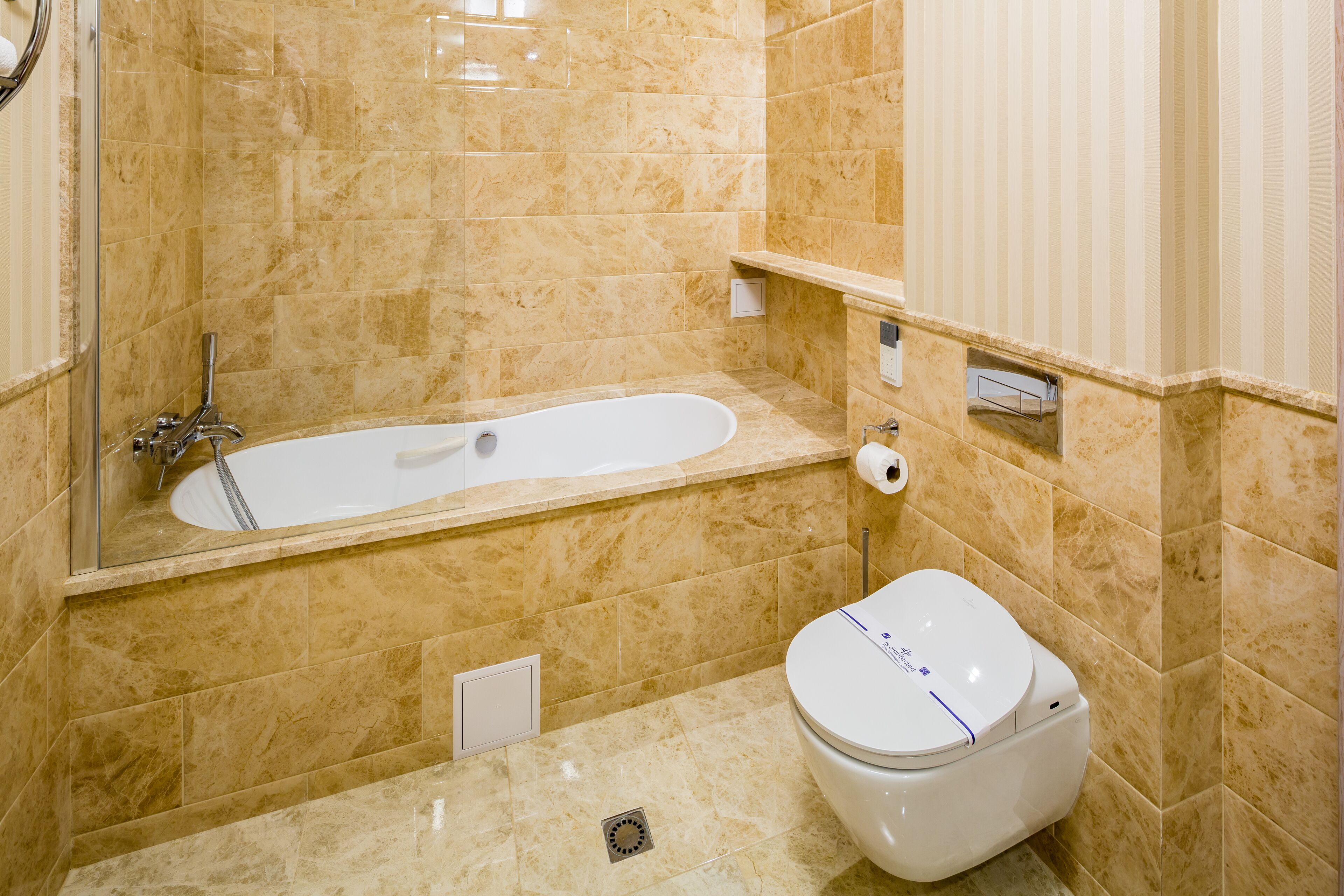 A bathroom with a bathtub, toilet, and a shower.