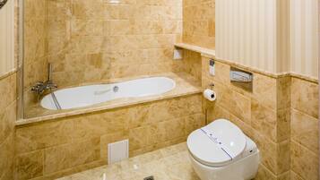 A bathroom with a bathtub, toilet, and a shower.