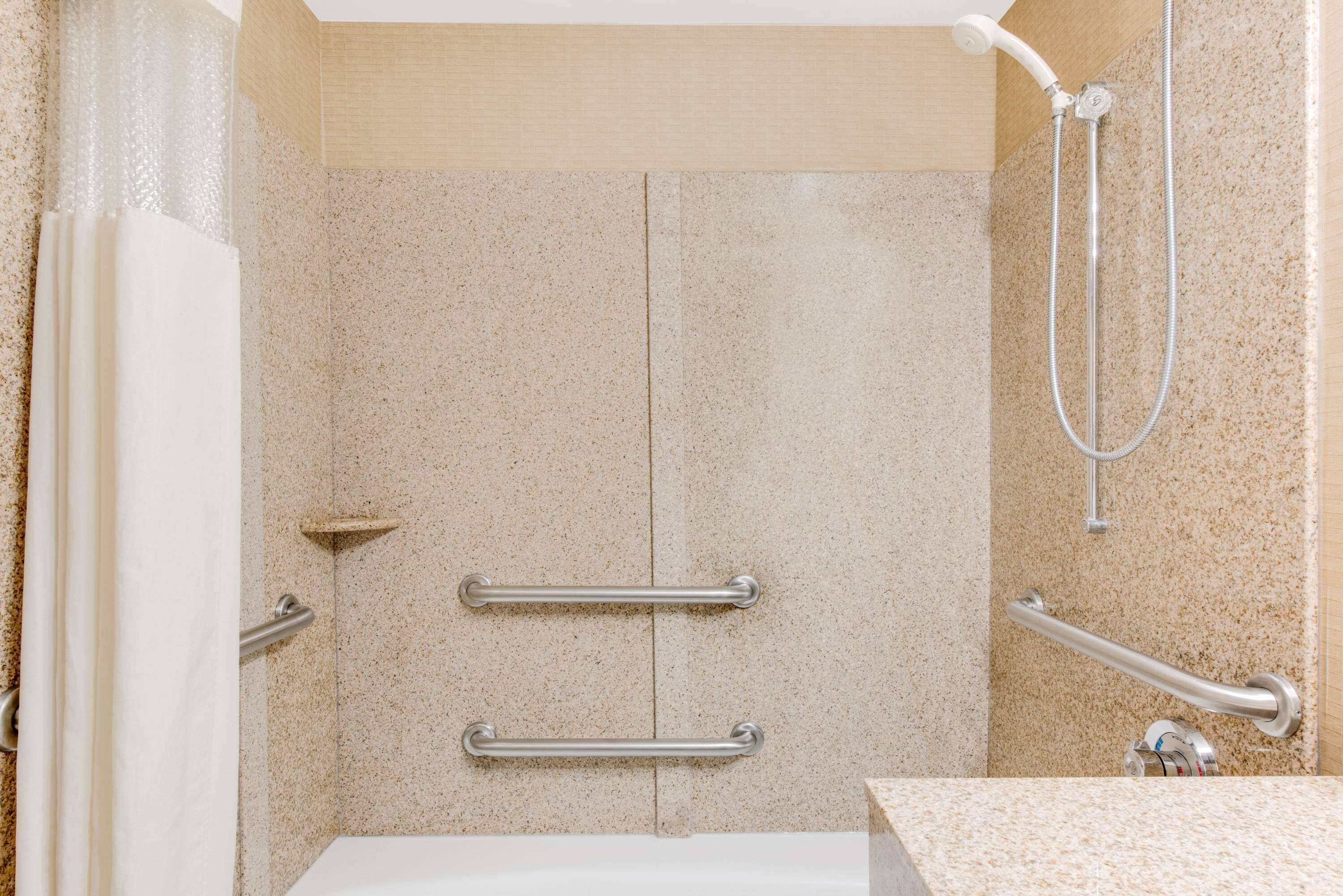 combined shower/bathtub, designer toiletries, hair dryer, towels