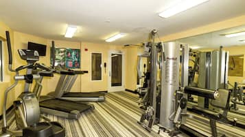 A gym with treadmills, a stationary bike, and weight machines.