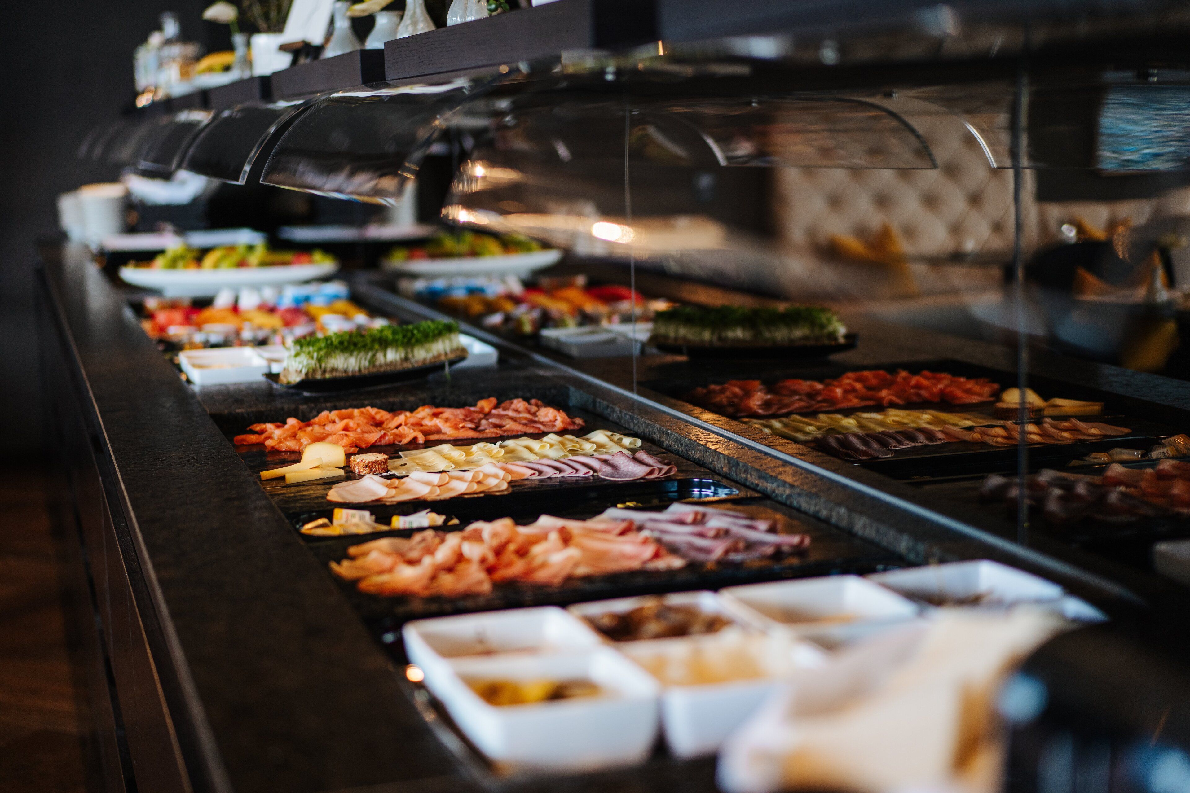 A buffet with various food items and condiments.