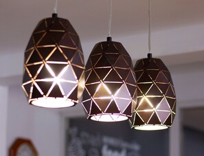 Three pendant lights with geometric patterns.