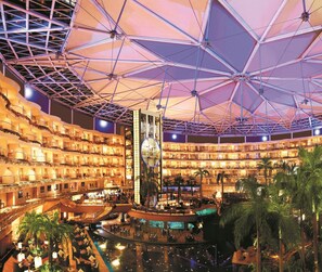 A multi-level hotel atrium with a central water feature, multiple balconies, and a large atrium ceiling. - Sahara Star (Mumbai)