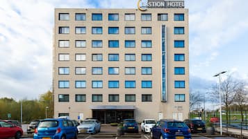 A multi-story hotel with a modern design, featuring a prominent sign at the top.