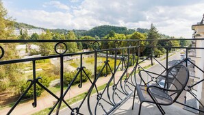 A balcony with a view of a park, a road, and a building in the background. - OREA Spa Hotel Palace Zvon Mariánské Lázně (Marianske Lazne)