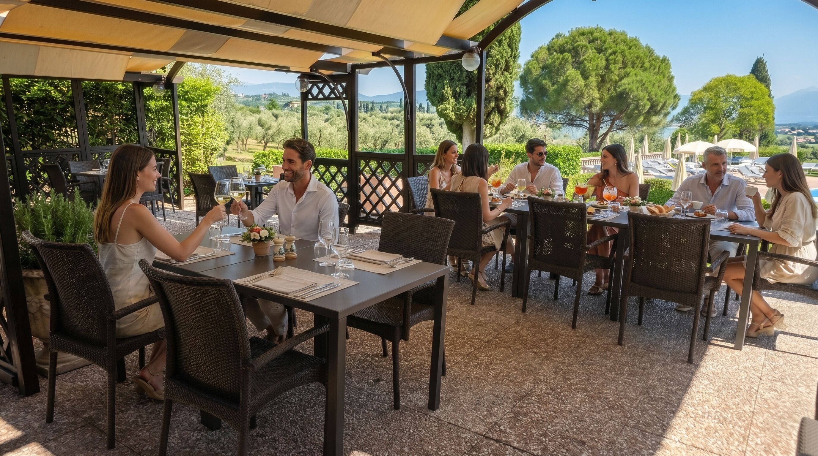 An outdoor dining area with tables and chairs, surrounded by greenery and a view of the landscape.