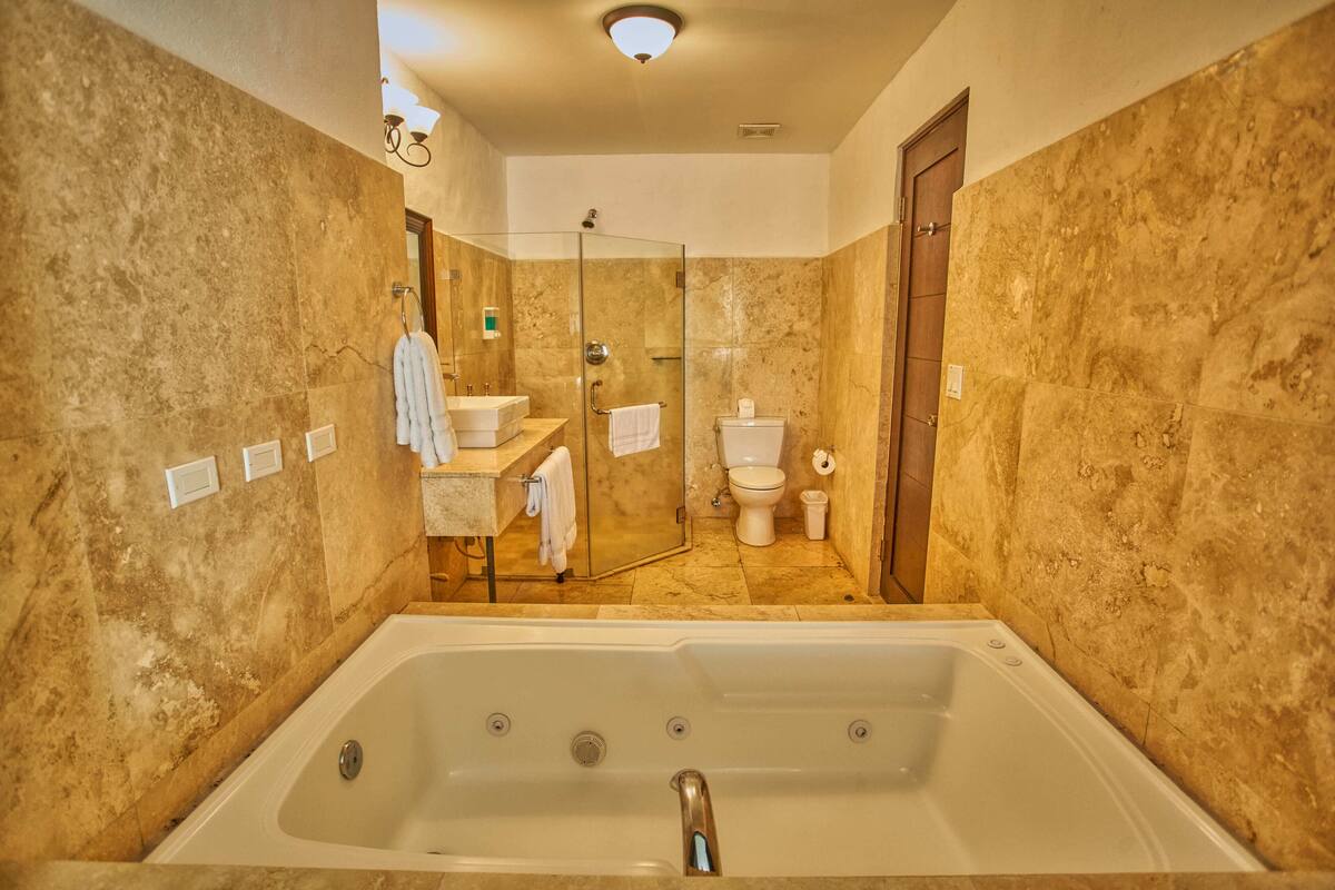 junior suite 1 king bed | bathroom | hair dryer, bathrobes, towels