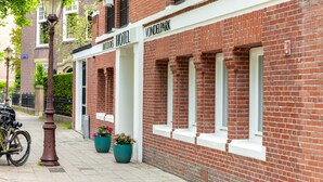A hotel with a brick facade, white-framed windows, and a sign reading 'Hotel Vondelpark.' - Dutch Design Hotel Vondelpark (Amsterdam)