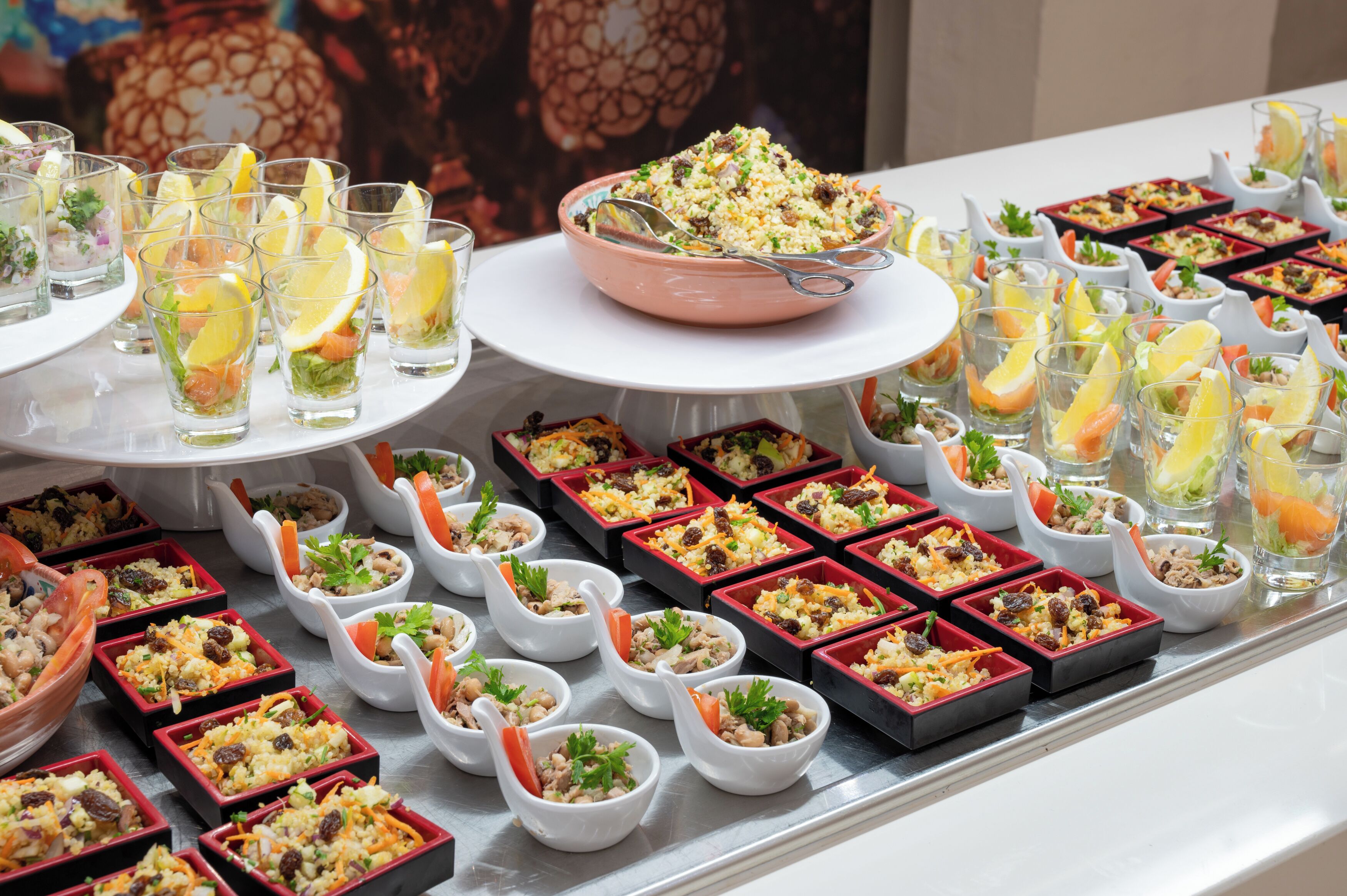 A buffet table with various food items and drinks.