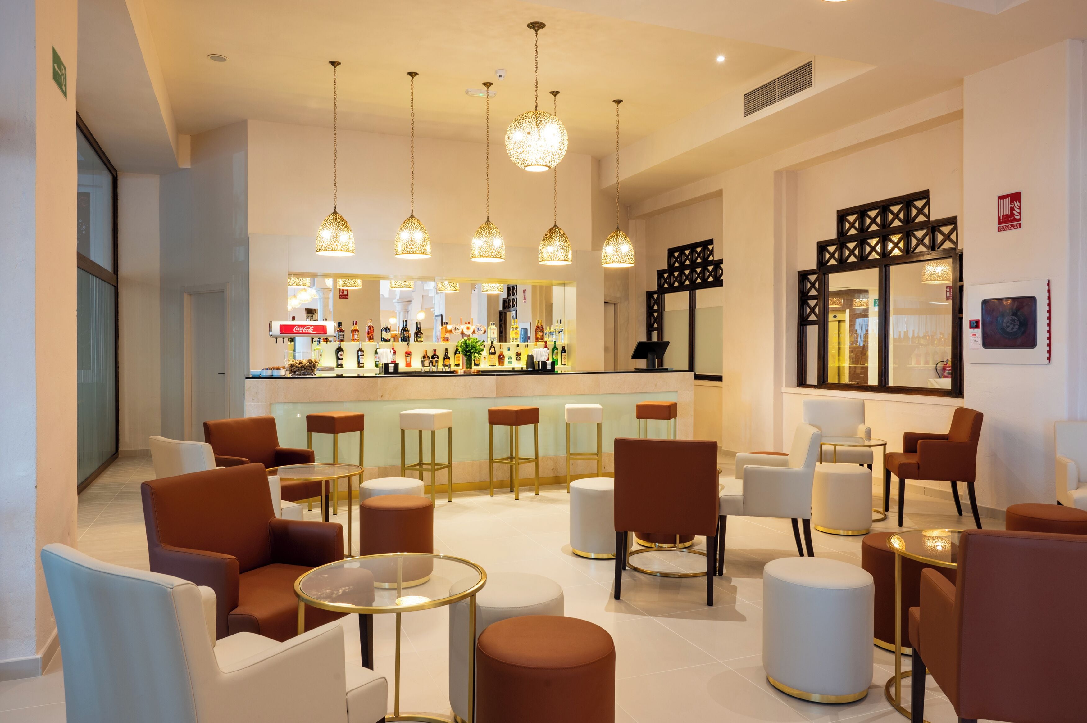A modern bar area with seating and a bar counter.