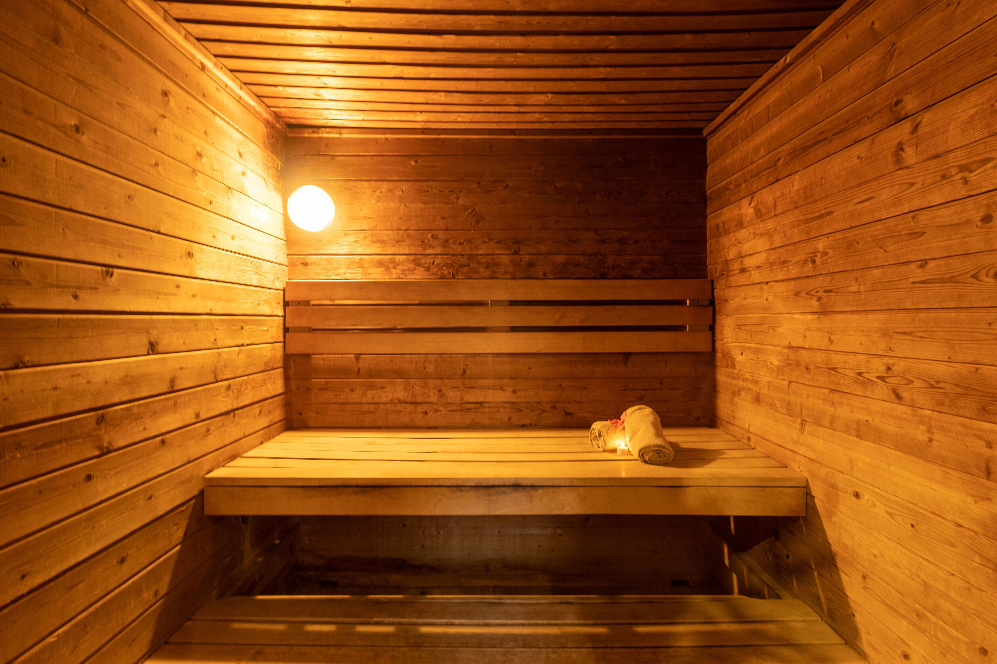 A sauna with wooden walls and benches.