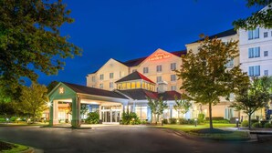 A hotel with a prominent Hilton Garden Inn sign, a covered entrance, and a well-lit facade. - Hilton Garden Inn Augusta (Augusta)