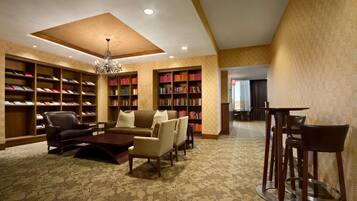 A library with bookshelves, a sofa, and a coffee table.