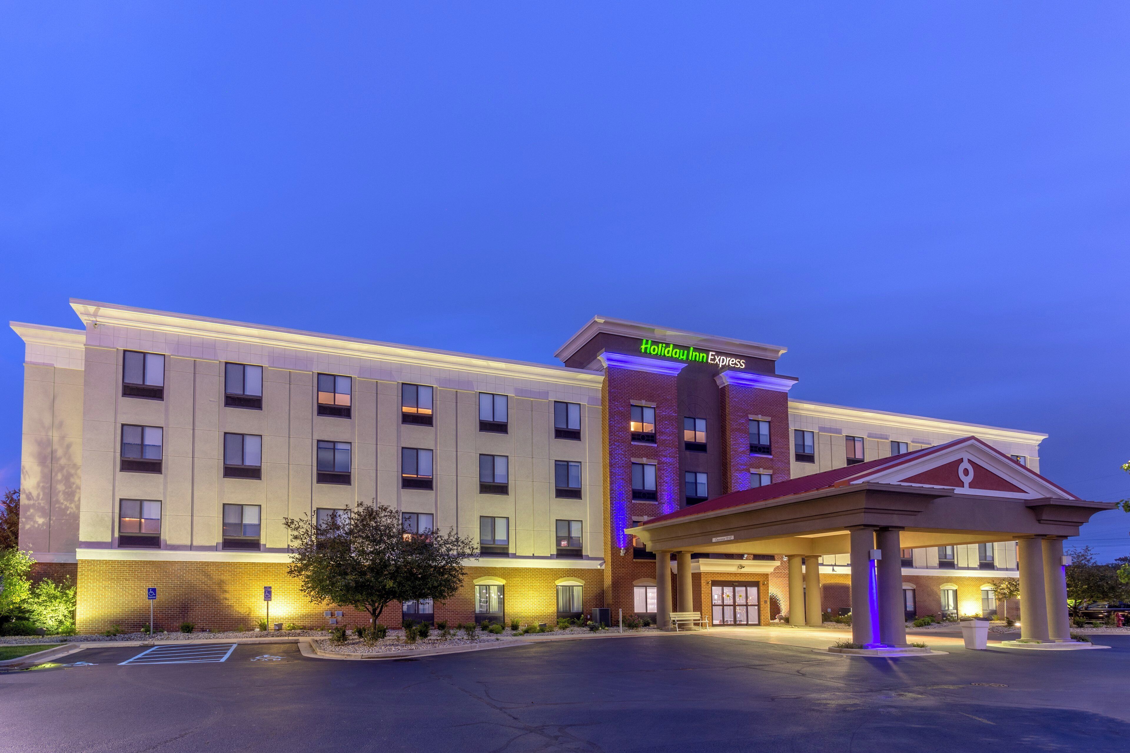 A Holiday Inn Express hotel with a modern facade, multiple floors, and a well-lit entrance.