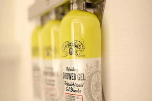 A row of yellow bottles labeled "J.R. Watkins Refreshing Shower Gel." - Holiday Inn Express Indianapolis - Southeast by IHG (Indianapolis)