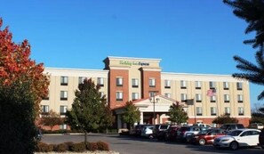 A Holiday Inn Express hotel with a parking lot and several cars.