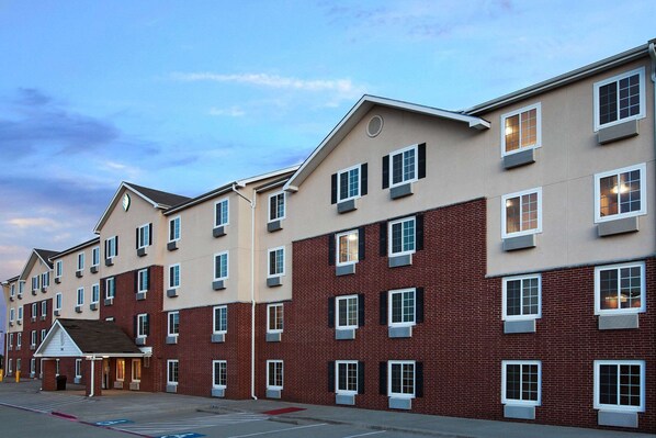 A multi-story hotel with a brick facade and multiple windows.