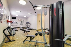 A gym with various exercise equipment, including treadmills, weight machines, and dumbbells. - MainStay Suites Texas Medical Center/Reliant Park (Houston)