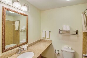 A bathroom with a sink, mirror, towel rack, and toilet. - MainStay Suites Texas Medical Center/Reliant Park (Houston)