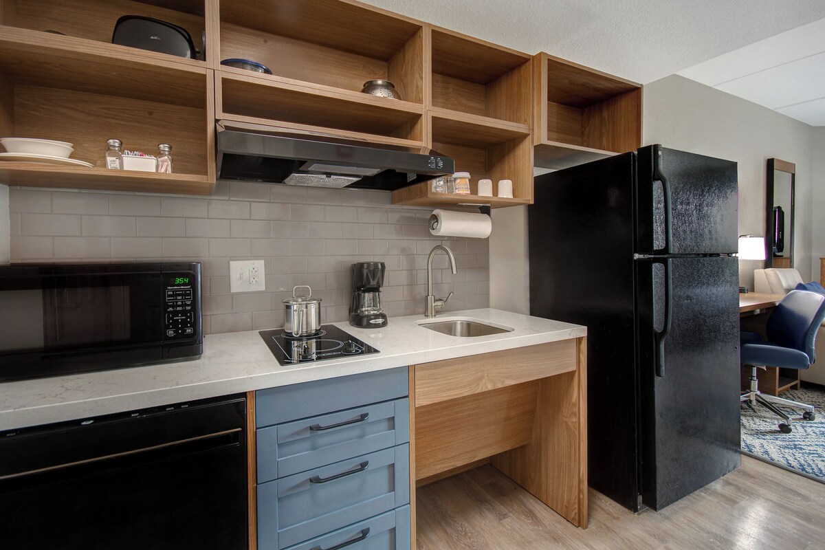 Premium bedding, desk, laptop workspace, blackout drapes