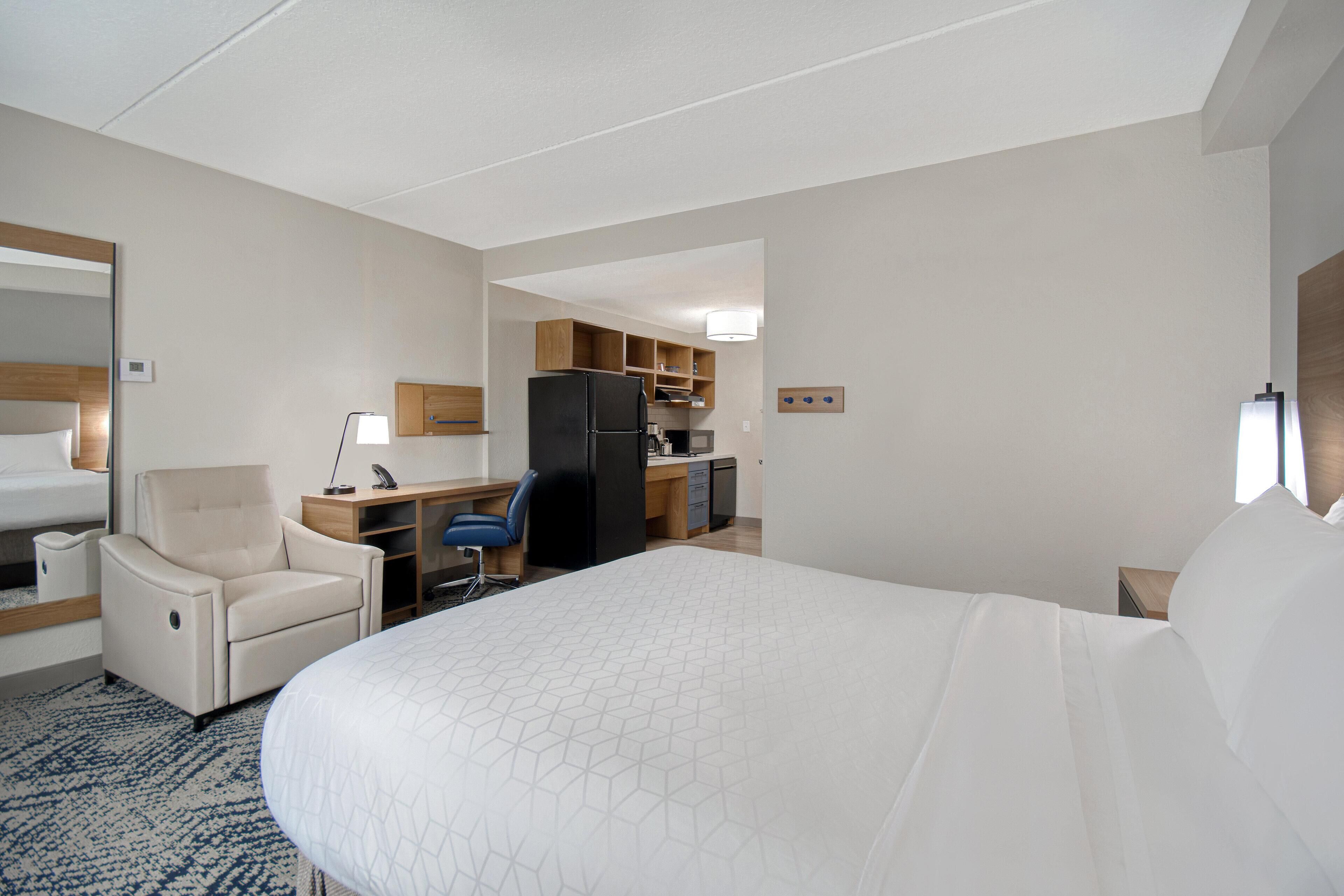 Premium bedding, desk, laptop workspace, blackout drapes