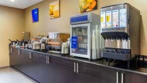 A self-service beverage station with multiple drink dispensers, a refrigerated display case, and a coffee machine. - Comfort Inn & Suites Amarillo East (Amarillo)