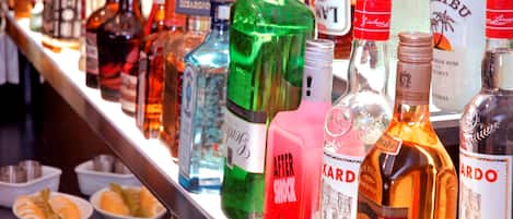A variety of liquor bottles on a shelf.